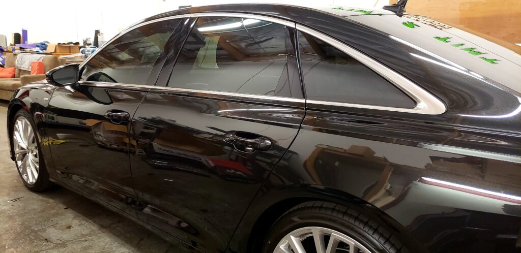 Car with professionally tinted windows, showcasing sleek and modern appearance