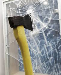 Security window film holding shattered glass after a break-in